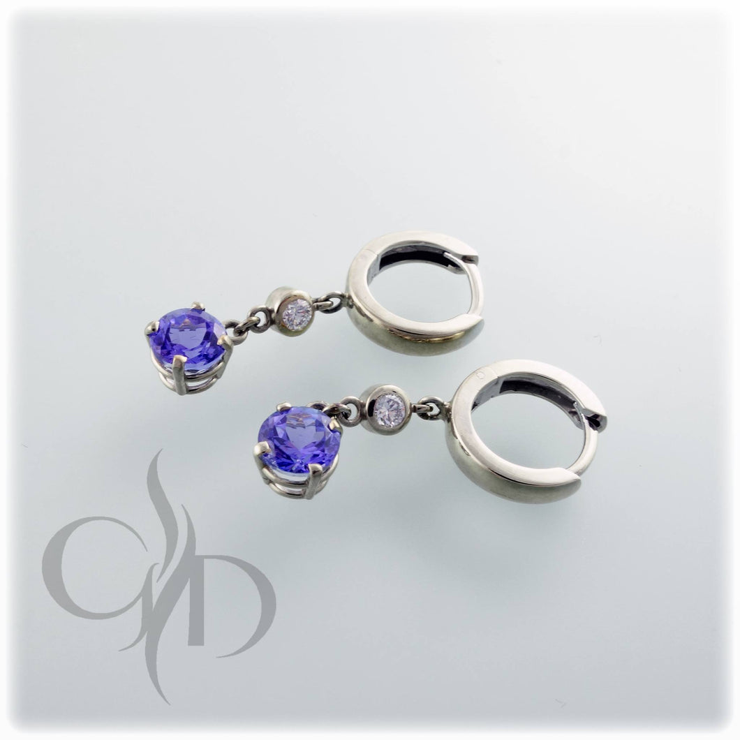 14K white gold hoop earrings with 1.47 total carat weight tanzanites and .13 total carat weight diamonds