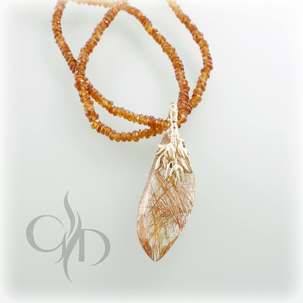 14k yellow gold and rutilated quartz pendant with 14k yellow and rose gold on a 18