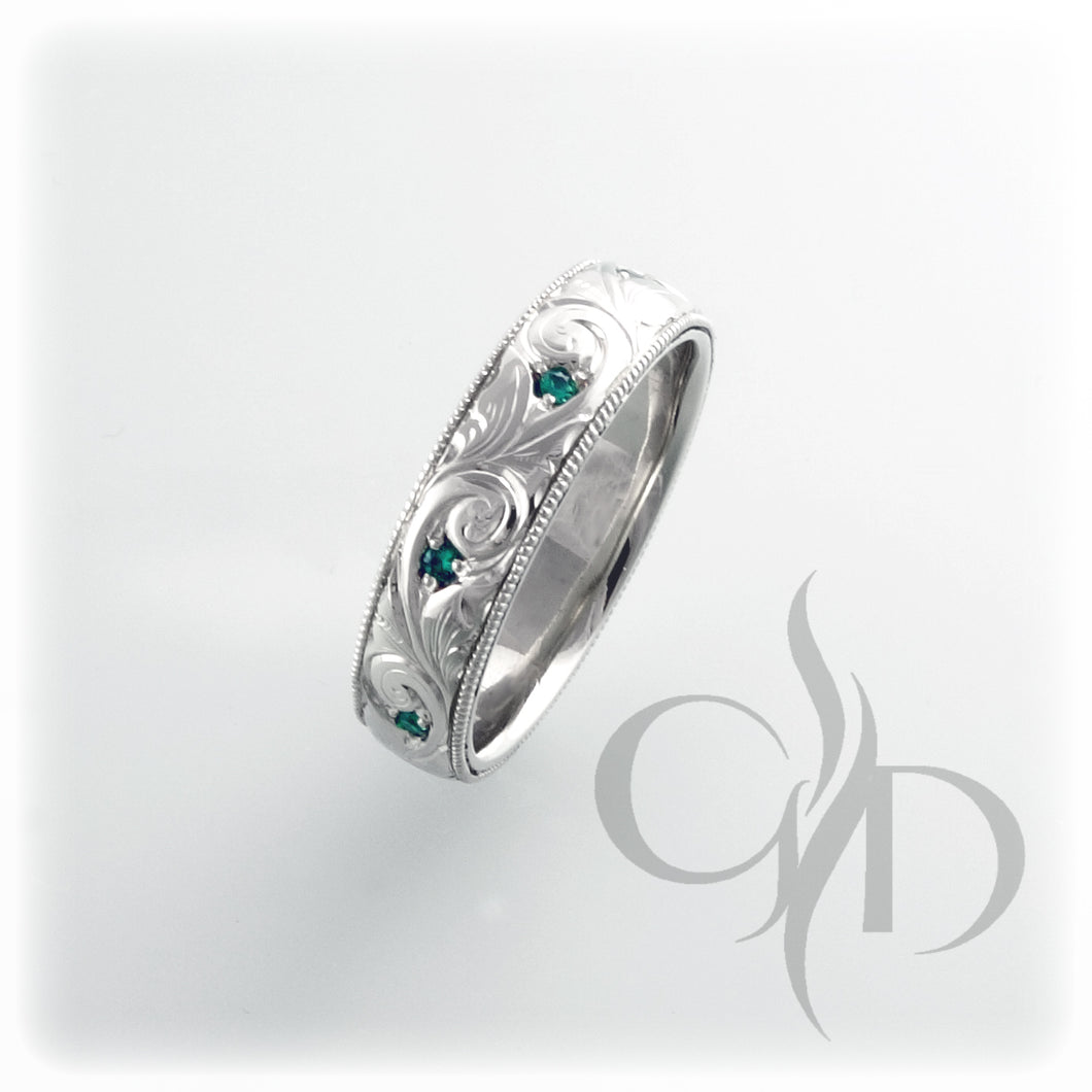 Hand engraved band with lovely emeralds