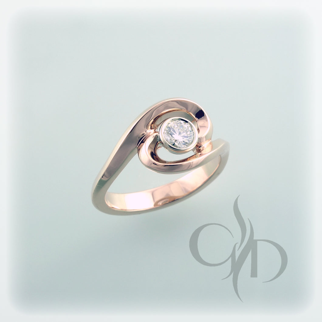 Swirl style ring with bezel set diamond